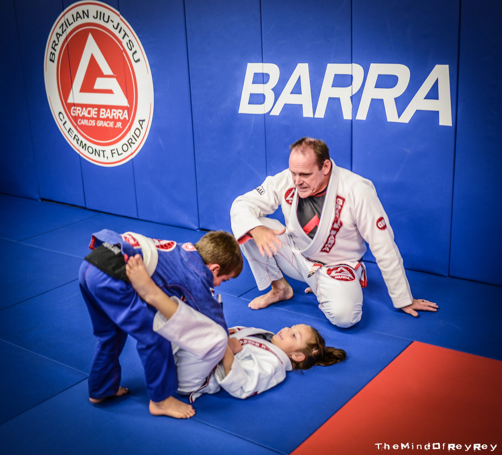 Dave teaching kids on the jiu-jitsu mats